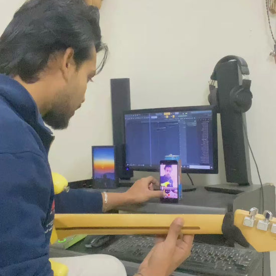 Side-by-side comparison video showing the difficulty of recording guitar covers with a shaky phone setup versus using a stable 360-degree guitar headstock phone mount for professional POV filming.